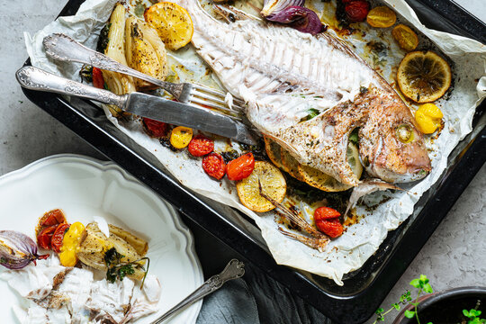 Cooked white fish on a tray