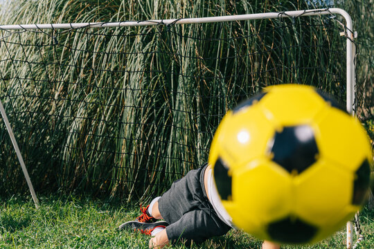 Someone catches the ball flying into the goal.