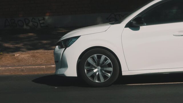 White car driving through the city streets