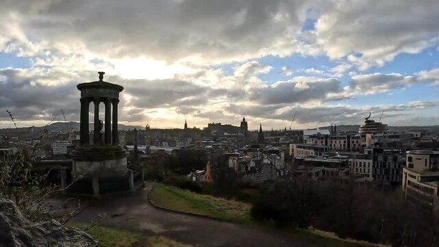 beautiful timelapse panorama of Edinburgh city before sunset, showing moving clouds and changing light over the historic urban skyline