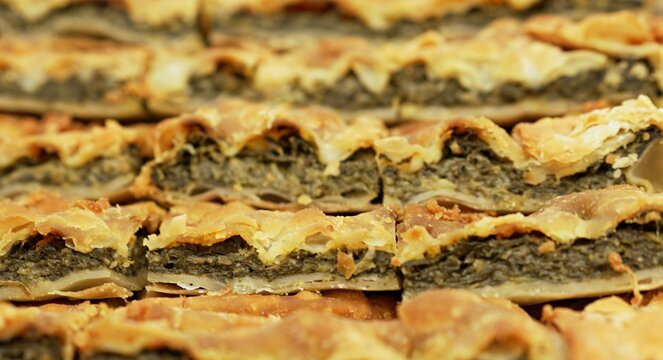 A delicious and rustic erbazzone reggiano, a classic Italian pastry filled with herbs and greens, presented in a neat grid of portions