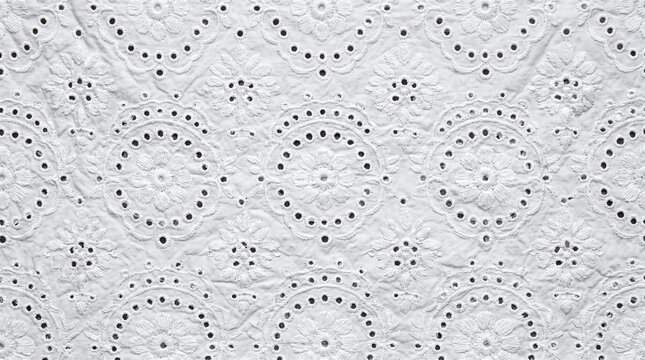 White cotton fabric with floral eyelet embroidery texture