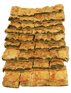 A delicious and rustic erbazzone reggiano, a classic Italian pastry filled with herbs and greens, presented in a neat grid of portions