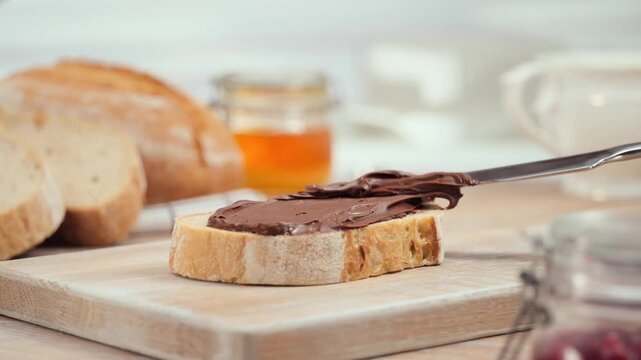 Chocolate spread on fresh bread slice close up homemade sweet breakfast