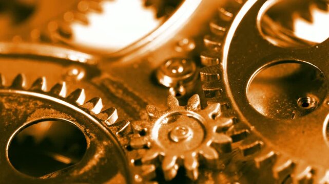 High-quality footage of warm golden-toned rotating gears. Ideal for business success, financial growth, and prestige engineering.
