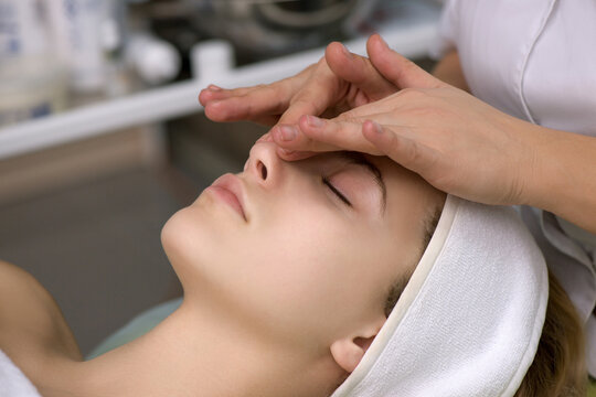 Face massage.  Close-up of young woman getting spa massage treatment at beauty spa salon.