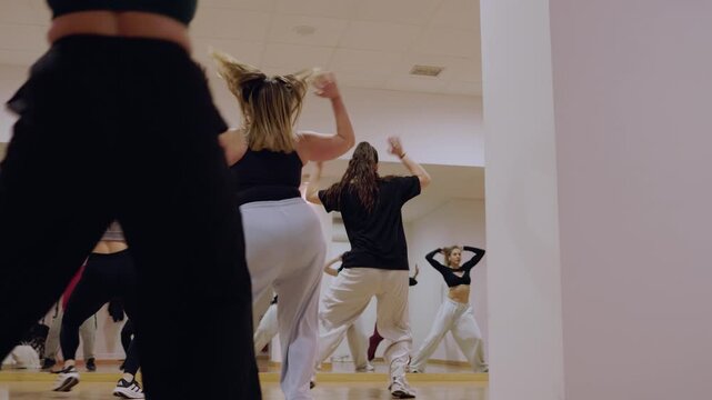 Diverse group of women learning hip hop choreography in dance studio