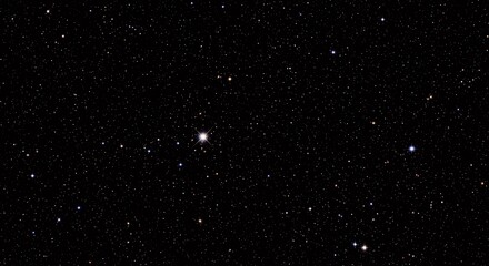 Obraz premium A bright star shines in the vast, dark expanse of the night sky, surrounded by countless distant stars.