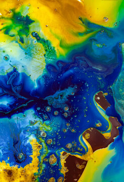 Bright colors blend together in a swirling abstract pattern with blue, green, and yellow shades