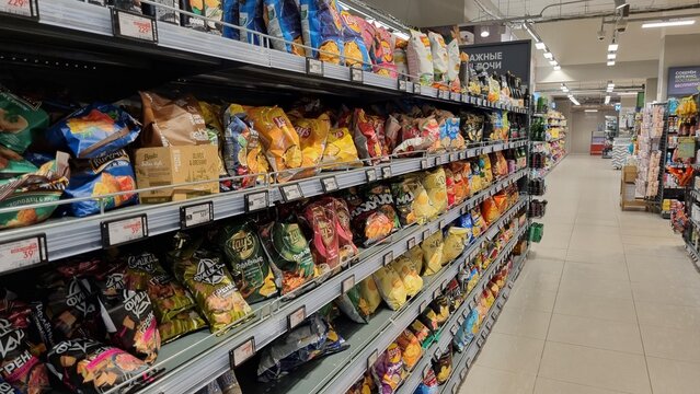 Snack aisle with chips and packaged food in supermarket