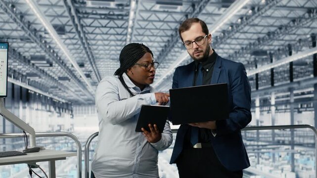 Optimizing workflow, microchips and woman with coworker using EDA software in smart factory. Using simulation tool, semiconductors and teamworking colleagues tracking circuit layout defects, camera B