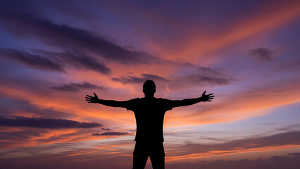 Fototapeta premium Silhouette Of A Person With Arms Wide Open Against A Dramatic Pixelated Sunset Sky