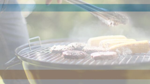 Cook flipping burger patties with tongs for even cooking in backyard making smoke and colored bands