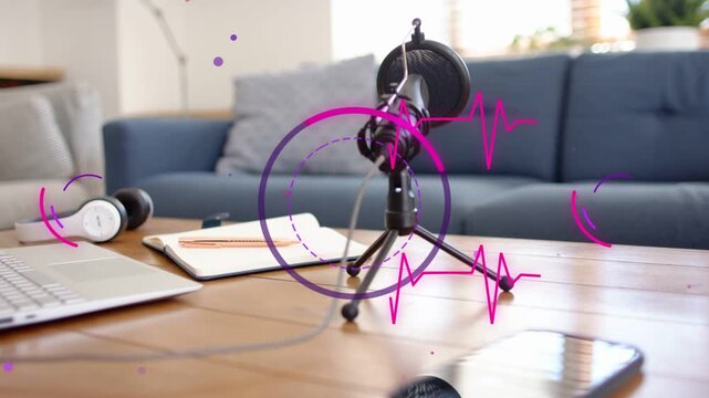 Appearing pulsing magenta graphics circling black microphone on coffee table, highlighting podcast