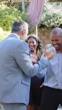 Man in light-blue suit approaching and initiating handshake becoming hug then dancing for business
