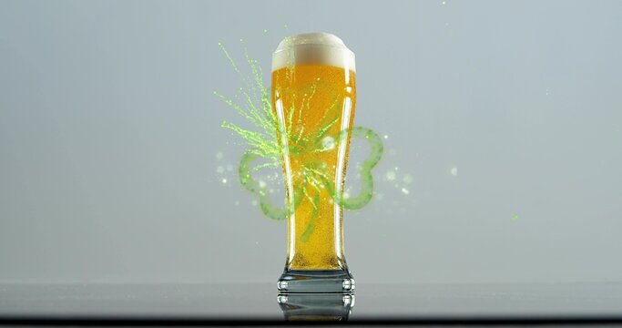 Erupting neon-green clover splash around pilsner glass on glossy table with amber beer, white foam