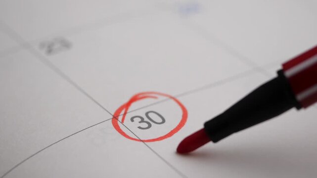 Red marker circles date 30 on calendar and writes credit card payment macro footage.