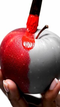 Red paint dripping onto half-painted apple