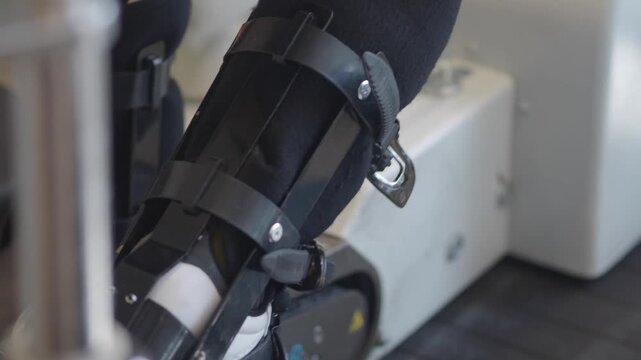Close up of person's legs and feet with orthotics and braces moving in dynamic motion.