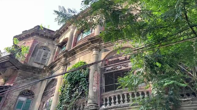 A majestic 19th-century heritage mansion in Kolkata featuring classic louvred shutters and intricate masonry characteristic of the British Raj.
