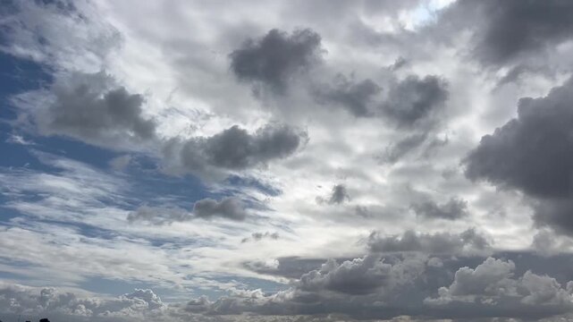 Mysterious clouds weave intricate patterns across the sky, capturing the essence of a changing atmosphere in serene yet dramatic tones
