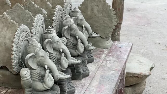Rows of meticulously crafted clay Ganesha statues awaiting finishing touches in the narrow lanes of Kumartuli, the iconic idol-makers' hub of West Bengal.