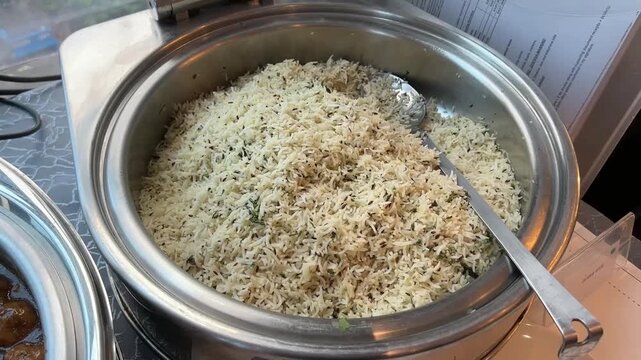 Long-grain basmati rice tempered with roasted cumin seeds and fresh coriander, served at a traditional festive event in India.