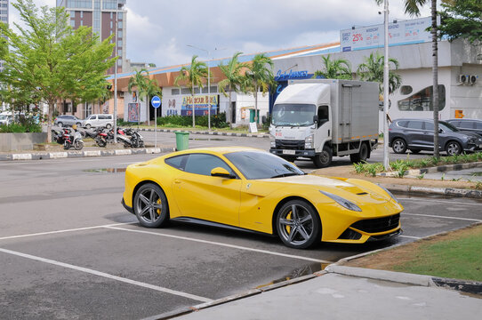 Batam, Indonesia - April 16, 2026: A yellow Ferrari sports car parked at Harbour Bay area in Batam, Indonesia.