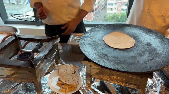 Freshly prepared Phulka chapatis being puffed to perfection at a traditional wedding banquet in Kolkata, West Bengal.