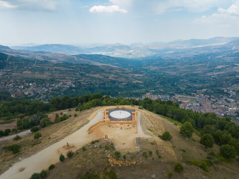 Aerial view of the Teatro di Andromeda stone theater on a hilltop overlooking the valley and mountains in Santo Stefano Quisquina, Sicilia, Italy.