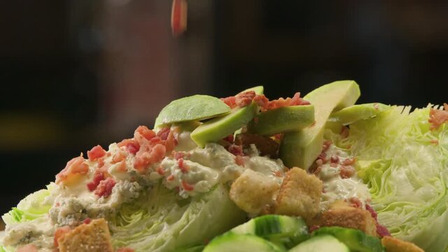 close up of a salad with bacon bits and avocado
