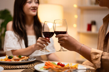 Asian young couple clinking glass of wine and drink on valentine's day. 