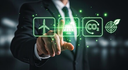 Naklejka premium A professional businessman in a dark suit extends his finger to touch glowing green digital icons representing wind energy solar power and carbon reduction.