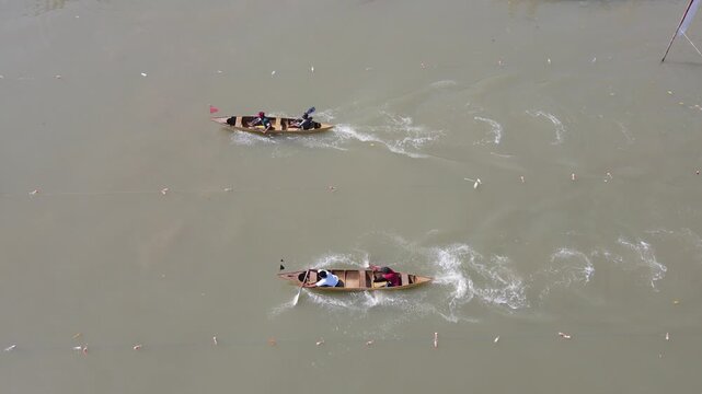 Aerial View of Traditional Wooden Boat Race on a River