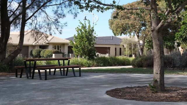 Residential homes near a quiet suburban neighbourhood park,&nbsp;surrounded by established trees with a picnic table and bench seats.&nbsp;Relaxed parkland living in Australia