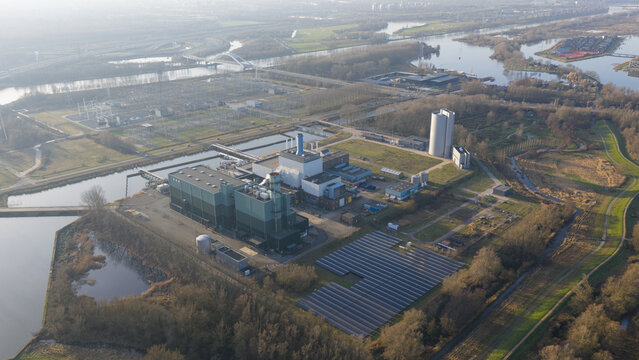 Aerial view of the Vattenfall Elektriciteitscentrale Diemen power plant with solar panels and industrial buildings near waterways in Diemen, Noord-Holland, Netherlands.