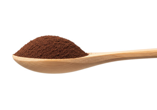 A natural wood tablespoon heaped with fine instant coffee powder, isolated on a transparent background in a macro, high-key studio shot. Concept of a quality ingredient