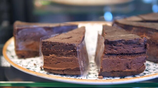 Chocolate cake slices on display in a bakery case