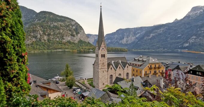 Scenic Hallstatt village with church and lake in Austrian Alps