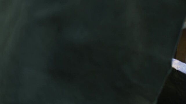 Chef Covering Huge Ancient Metal Cauldron of Pilaf With Dark Cloth, Close-Up