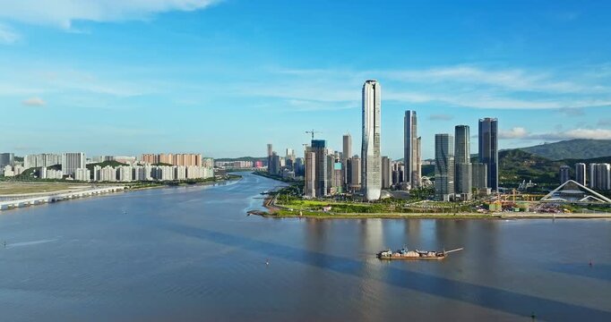 Drone view of modern financial district skyscrapers and city skyline by the river, Zhuhai, China.