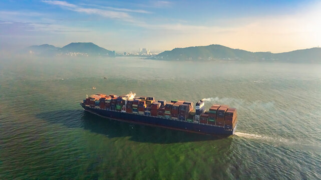 Aerial top down view of a large container cargo ship in motion over open ocean Ba Ria Vung Tau, Ho Chi Minh city, Vietnam