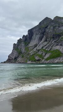 Stunning view of Bunes beach with mountains meeting the Arctic Ocean, Lofoten Islands, Norway