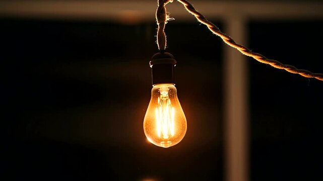 Glowing Light Bulb on String Lights at Night.