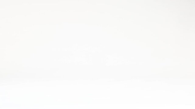 Striped Wooden Bead Bouncing Across a Plain White Background