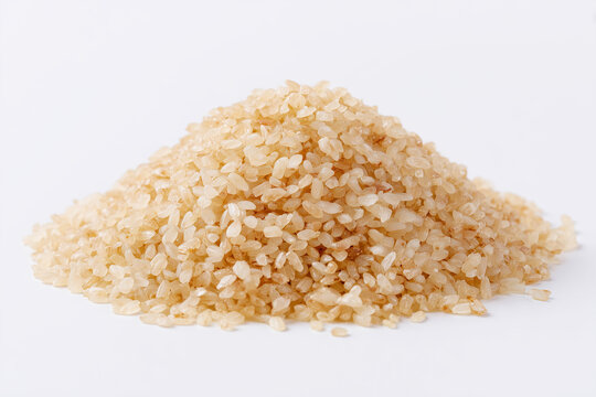 Pile of brown rice grains natural whole grain ingredient isolated on white background
