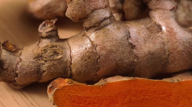 A vibrant sliced piece of raw turmeric root