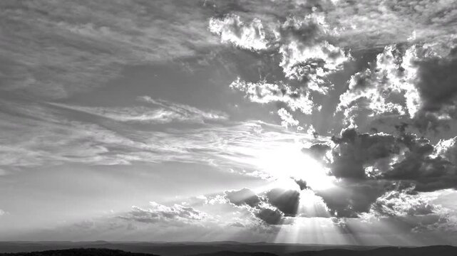 A black and white hyperlapse sequence capturing the richly layered sky at dusk. Clean copy space in the center makes this ideal for title cards, presentations, and promotional overlays.