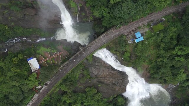 Aerial View of Dudhsagar Waterfall Cascading Behind Railway Bridge in Goa India