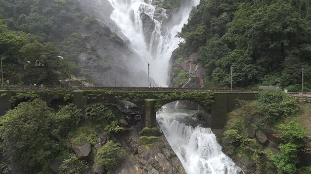 Aerial View of Dudhsagar Waterfall Cascading Behind Railway Bridge in Goa India